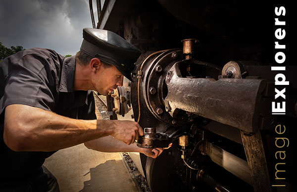 Driver oiling steam train after Driver oiling steam train after