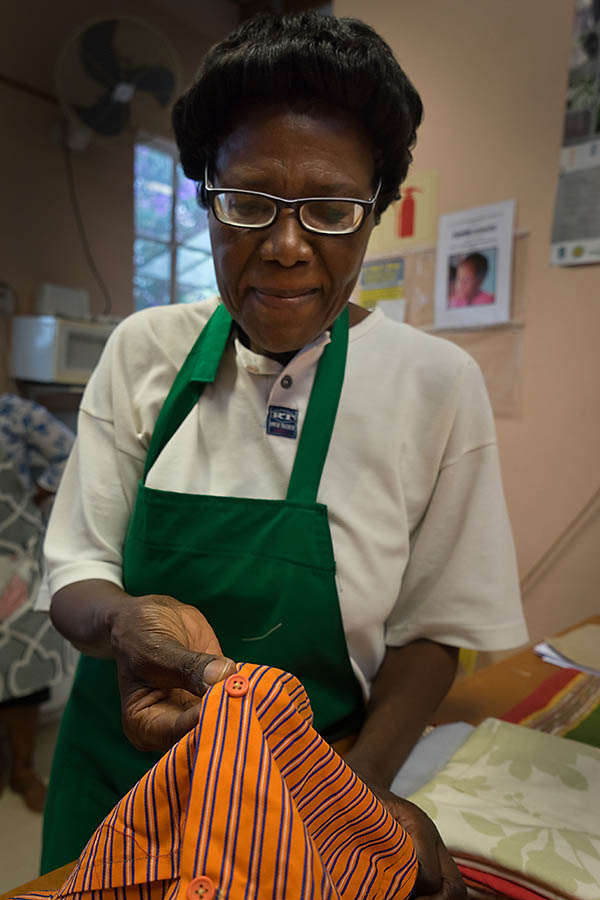 Thandi inspecting sewing - required low light photography 